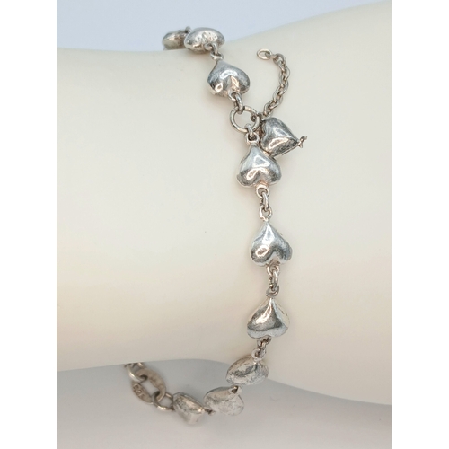 8 - A 925 Sterling Silver Heart Link Bracelet - 18cm length. Formed with a series of linked heart-shaped... 