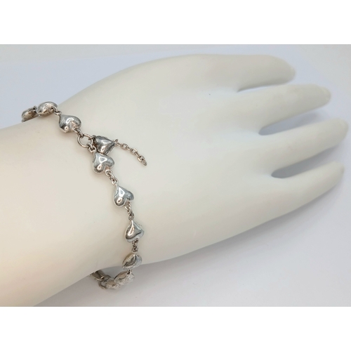 8 - A 925 Sterling Silver Heart Link Bracelet - 18cm length. Formed with a series of linked heart-shaped... 