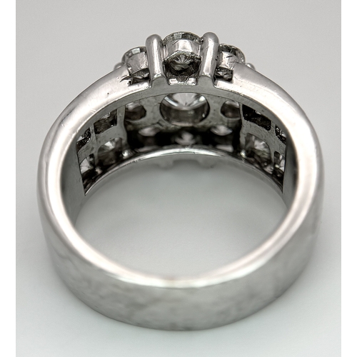 687 - An 18K White Gold and Diamond Dress Ring. A 0.75ct round brilliant cut diamond centre stone with a 2... 