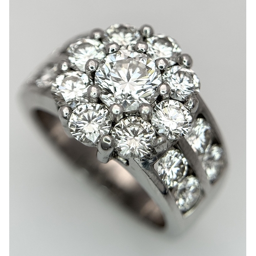687 - An 18K White Gold and Diamond Dress Ring. A 0.75ct round brilliant cut diamond centre stone with a 2... 