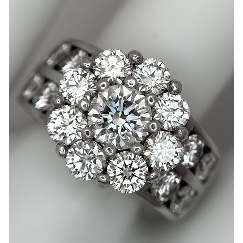 687 - An 18K White Gold and Diamond Dress Ring. A 0.75ct round brilliant cut diamond centre stone with a 2... 