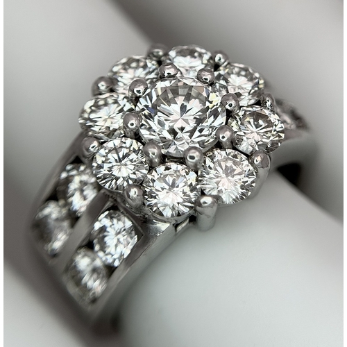 687 - An 18K White Gold and Diamond Dress Ring. A 0.75ct round brilliant cut diamond centre stone with a 2... 