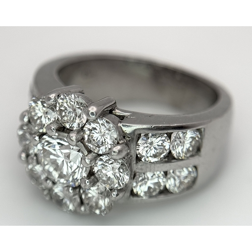 687 - An 18K White Gold and Diamond Dress Ring. A 0.75ct round brilliant cut diamond centre stone with a 2... 
