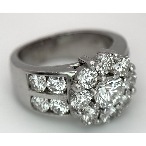 687 - An 18K White Gold and Diamond Dress Ring. A 0.75ct round brilliant cut diamond centre stone with a 2... 