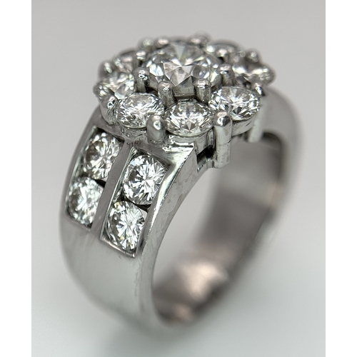 687 - An 18K White Gold and Diamond Dress Ring. A 0.75ct round brilliant cut diamond centre stone with a 2... 