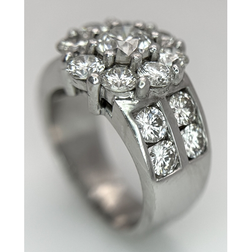 687 - An 18K White Gold and Diamond Dress Ring. A 0.75ct round brilliant cut diamond centre stone with a 2... 