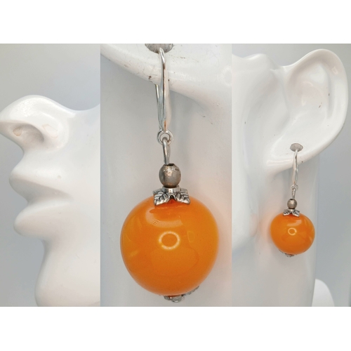 22 - A Pretty Pair of 925 Sterling Silver Amber Drop Earrings. Each earring is set with a round amber bea... 