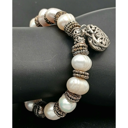 25 - A Pretty Freshwater Pearl and Silver-Tone Heart Charm Bracelet. Set with irregular shaped freshwater... 