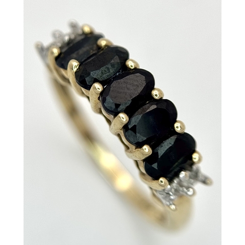 32 - A 9K Yellow Gold Sapphire and Diamond Ring. Five oval cut sapphires with diamond accents either end.... 