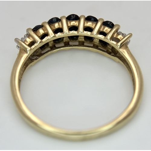 32 - A 9K Yellow Gold Sapphire and Diamond Ring. Five oval cut sapphires with diamond accents either end.... 