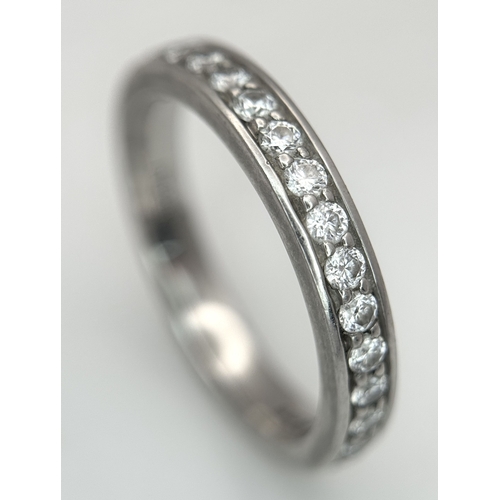 43 - A 950 Platinum and Diamond Half Eternity Ring. 4mm width. Size M 1/2. 5.7g total weight. Channel and... 