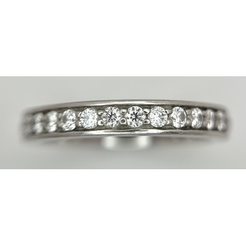 43 - A 950 Platinum and Diamond Half Eternity Ring. 4mm width. Size M 1/2. 5.7g total weight. Channel and... 
