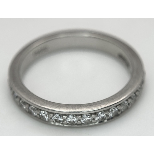 43 - A 950 Platinum and Diamond Half Eternity Ring. 4mm width. Size M 1/2. 5.7g total weight. Channel and... 