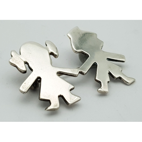 27 - A Vintage Sterling Silver Brooch. Formed as a stylised boy and girl holding hands. Measures 4.4cm x ... 