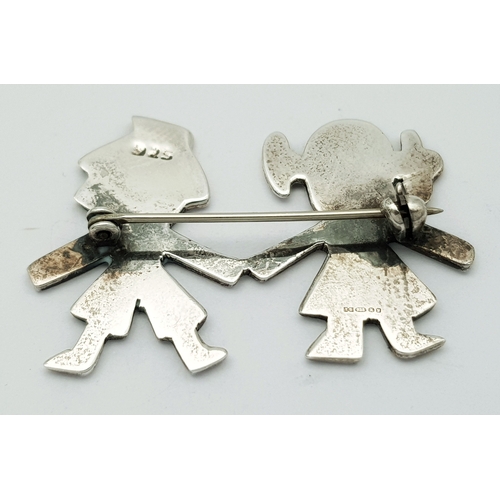 27 - A Vintage Sterling Silver Brooch. Formed as a stylised boy and girl holding hands. Measures 4.4cm x ... 