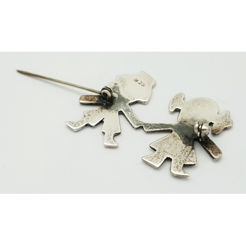 27 - A Vintage Sterling Silver Brooch. Formed as a stylised boy and girl holding hands. Measures 4.4cm x ... 