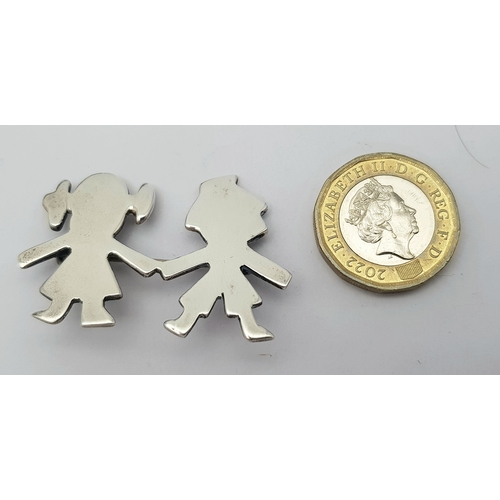 27 - A Vintage Sterling Silver Brooch. Formed as a stylised boy and girl holding hands. Measures 4.4cm x ... 