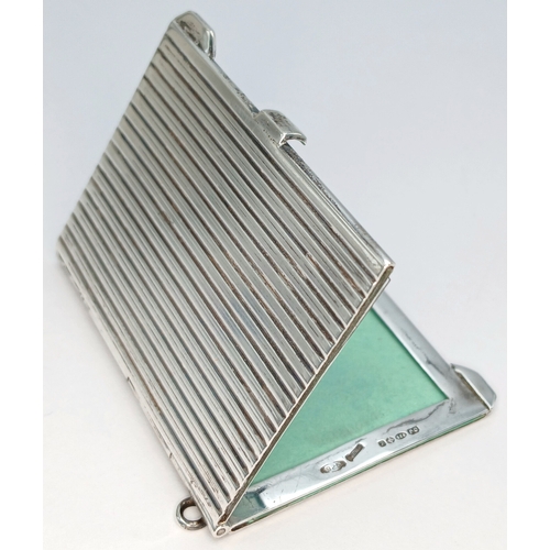 7 - A Hallmarked Sterling Silver Double Photograph Frame Pendant. The rectangular frame has an engine-tu... 