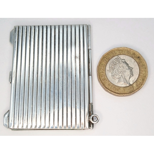 7 - A Hallmarked Sterling Silver Double Photograph Frame Pendant. The rectangular frame has an engine-tu... 