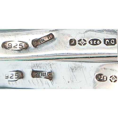 7 - A Hallmarked Sterling Silver Double Photograph Frame Pendant. The rectangular frame has an engine-tu... 