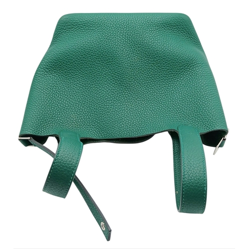 41 - An Hermès Picotin Lock Green Leather Handbag. Green leather exterior with dual top handles, silver-t... 