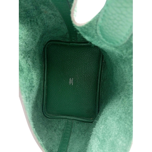 41 - An Hermès Picotin Lock Green Leather Handbag. Green leather exterior with dual top handles, silver-t... 
