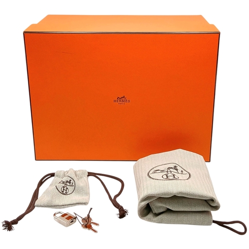 41 - An Hermès Picotin Lock Green Leather Handbag. Green leather exterior with dual top handles, silver-t... 