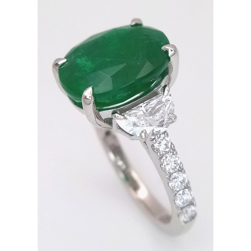 46 - A Stunning 950 Platinum Natural Emerald and Diamond Cocktail Ring. Set with an oval cut 5.69ct natur... 