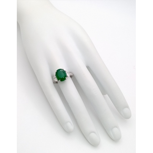 46 - A Stunning 950 Platinum Natural Emerald and Diamond Cocktail Ring. Set with an oval cut 5.69ct natur... 