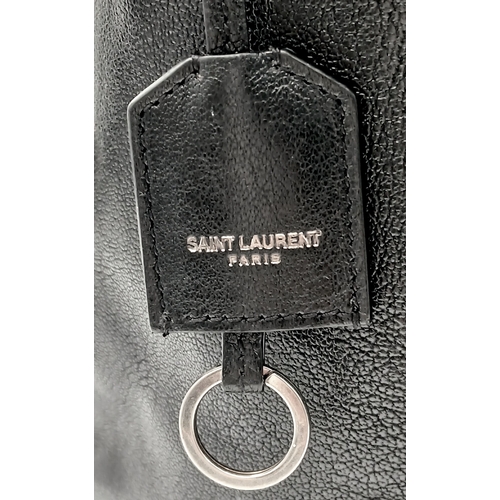 55 - A Black Yves Saint Laurent Heart Studded Tote Bag. Black leather exterior with silver-toned heart-sh... 