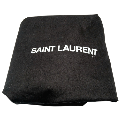 55 - A Black Yves Saint Laurent Heart Studded Tote Bag. Black leather exterior with silver-toned heart-sh... 