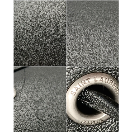 55 - A Black Yves Saint Laurent Heart Studded Tote Bag. Black leather exterior with silver-toned heart-sh... 