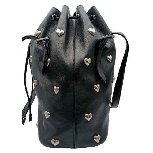 55 - A Black Yves Saint Laurent Heart Studded Tote Bag. Black leather exterior with silver-toned heart-sh... 