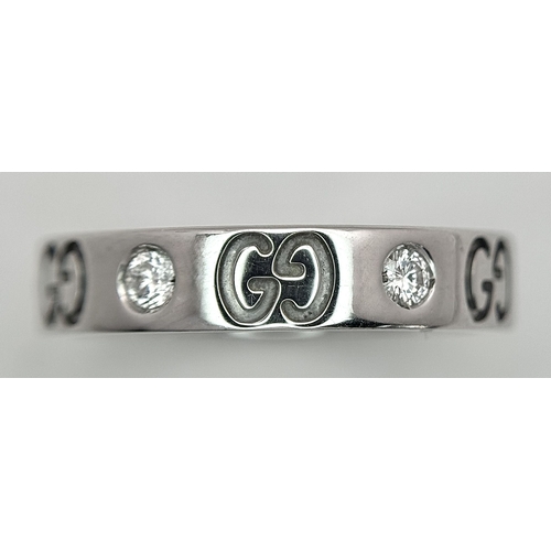 60 - A Gucci Designer 18K White Gold and Diamond Band Ring. Alternating deep set diamonds and double G mo... 