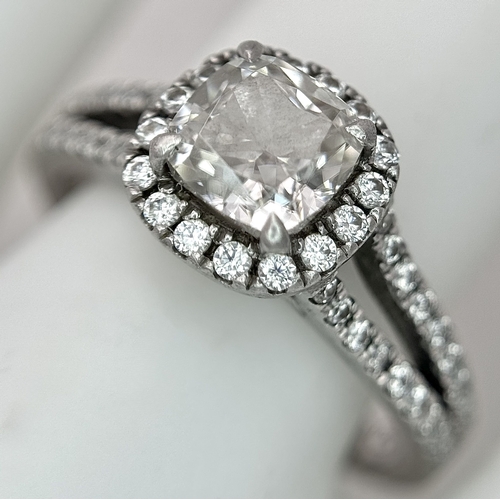 15 - A Platinum 950 and Diamond Dress Ring. A circa 1ct cushion cut diamond centre stone having J colour ... 