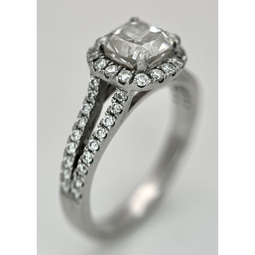 15 - A Platinum 950 and Diamond Dress Ring. A circa 1ct cushion cut diamond centre stone having J colour ... 