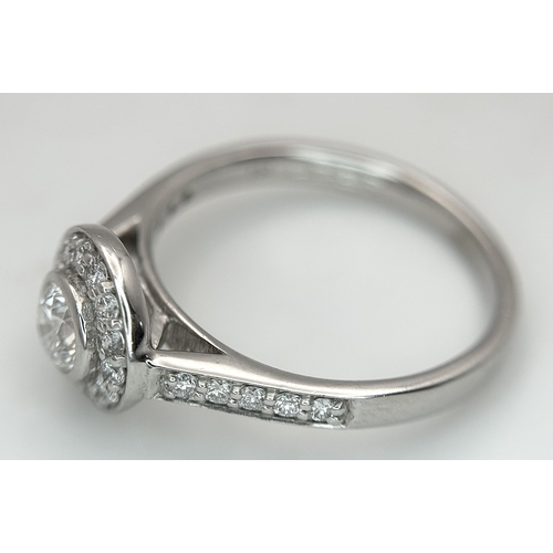 132 - An 18K White Gold, Diamond Solitaire Ring with a Halo and Diamond Set Shoulders. Centre Stone 0.26ct... 