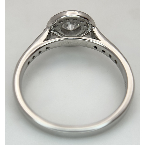 132 - An 18K White Gold, Diamond Solitaire Ring with a Halo and Diamond Set Shoulders. Centre Stone 0.26ct... 