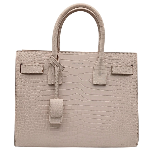 54 - A Baby Pink Saint Laurent Sac de Jour Handbag. Baby pink crocodile-embossed leather exterior with si... 
