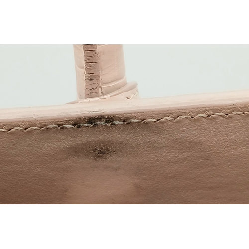 54 - A Baby Pink Saint Laurent Sac de Jour Handbag. Baby pink crocodile-embossed leather exterior with si... 