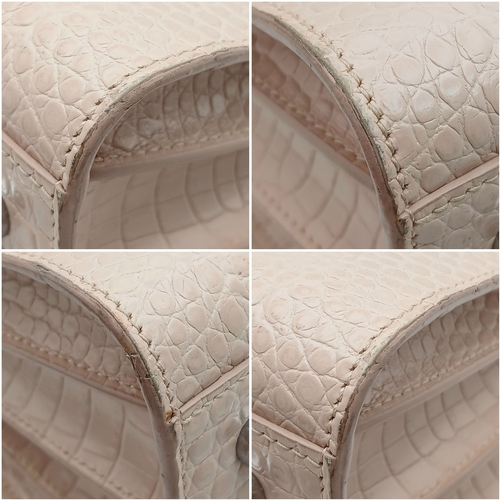 54 - A Baby Pink Saint Laurent Sac de Jour Handbag. Baby pink crocodile-embossed leather exterior with si... 