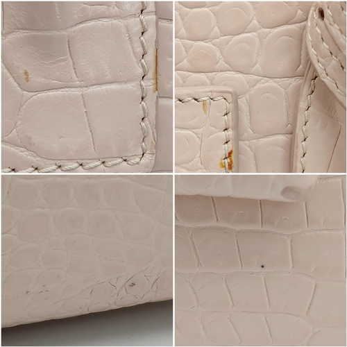 54 - A Baby Pink Saint Laurent Sac de Jour Handbag. Baby pink crocodile-embossed leather exterior with si... 