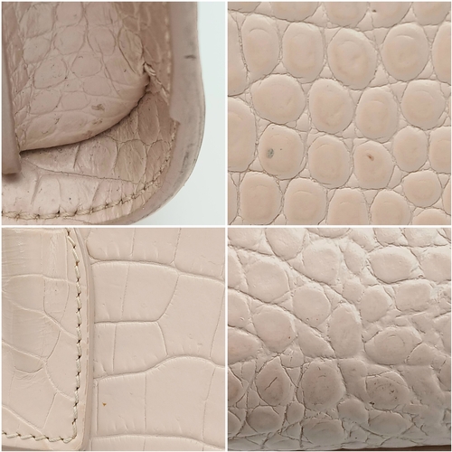 54 - A Baby Pink Saint Laurent Sac de Jour Handbag. Baby pink crocodile-embossed leather exterior with si... 