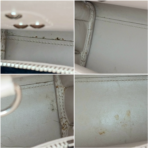 54 - A Baby Pink Saint Laurent Sac de Jour Handbag. Baby pink crocodile-embossed leather exterior with si... 
