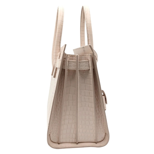 54 - A Baby Pink Saint Laurent Sac de Jour Handbag. Baby pink crocodile-embossed leather exterior with si... 