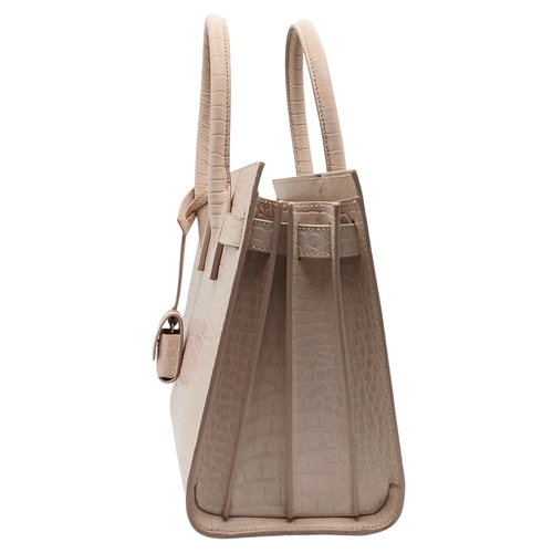 54 - A Baby Pink Saint Laurent Sac de Jour Handbag. Baby pink crocodile-embossed leather exterior with si... 