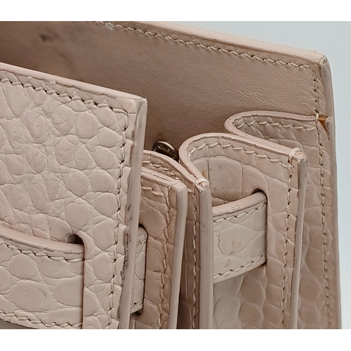 54 - A Baby Pink Saint Laurent Sac de Jour Handbag. Baby pink crocodile-embossed leather exterior with si... 