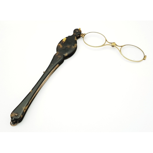 94 - An Antique Pair of Folding Lorgnette Glasses. Spring loaded with a push button-mechanism to flip ope... 