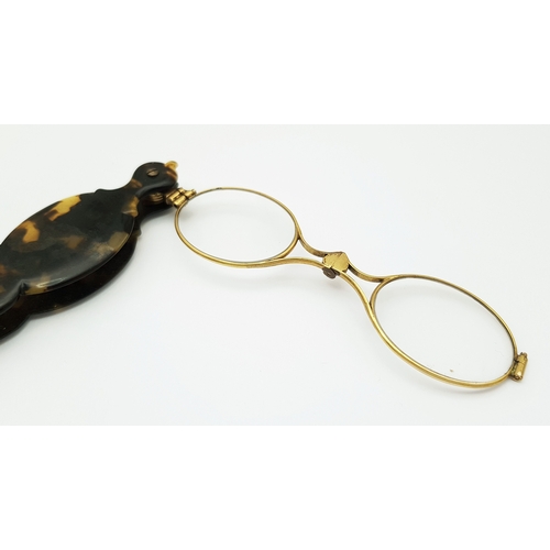 94 - An Antique Pair of Folding Lorgnette Glasses. Spring loaded with a push button-mechanism to flip ope... 