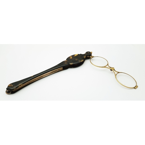 94 - An Antique Pair of Folding Lorgnette Glasses. Spring loaded with a push button-mechanism to flip ope... 